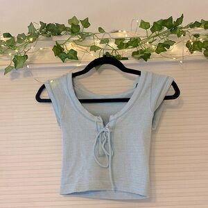 Chambray blue cropped top with tie in the middle: waffle knit pattern